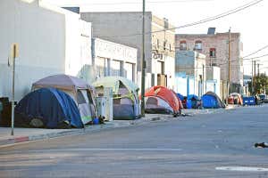An image of tents set up on an urban street